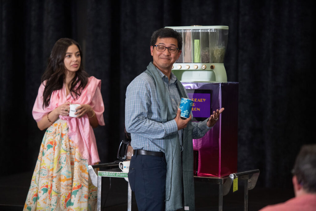 Two people with a prototype of a BrUW bot.