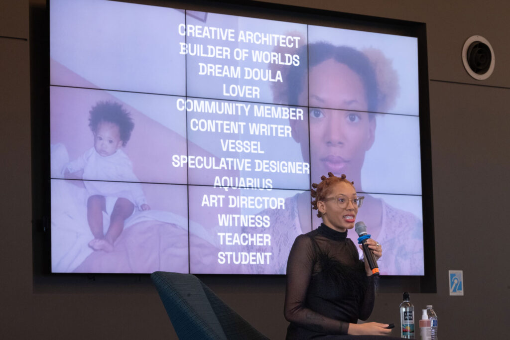 A person in front of a presentation screen.
