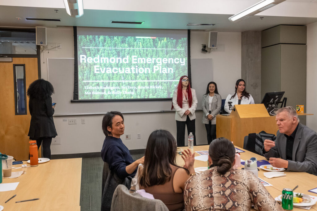 A group of people presenting to a room.