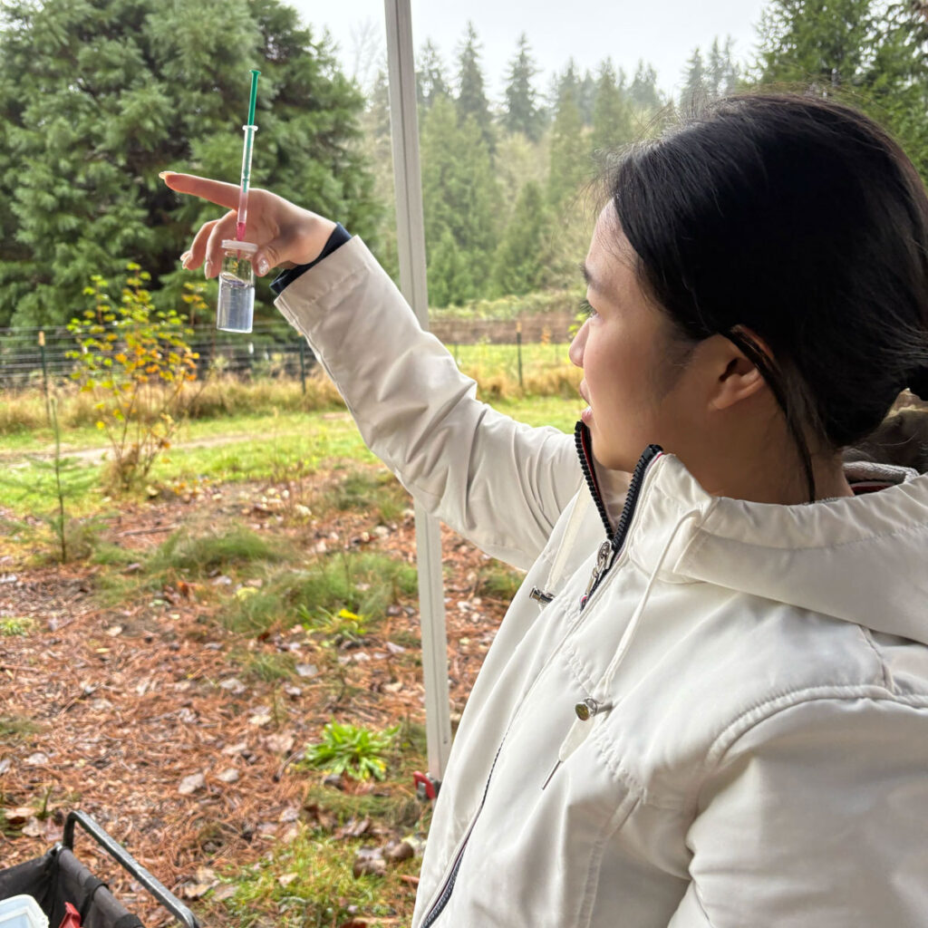 A person holding a water sample.