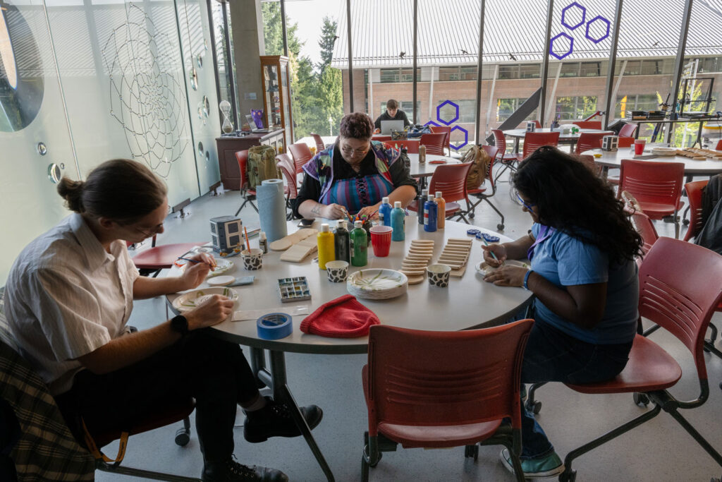 A group of people crafting at a table.