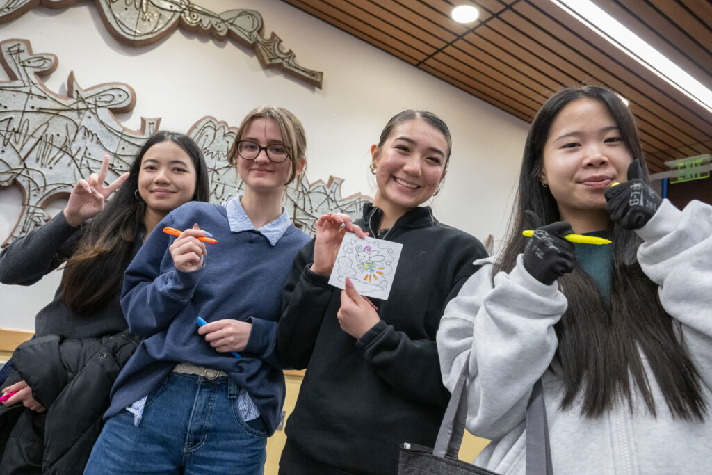 A group of people holding up art.