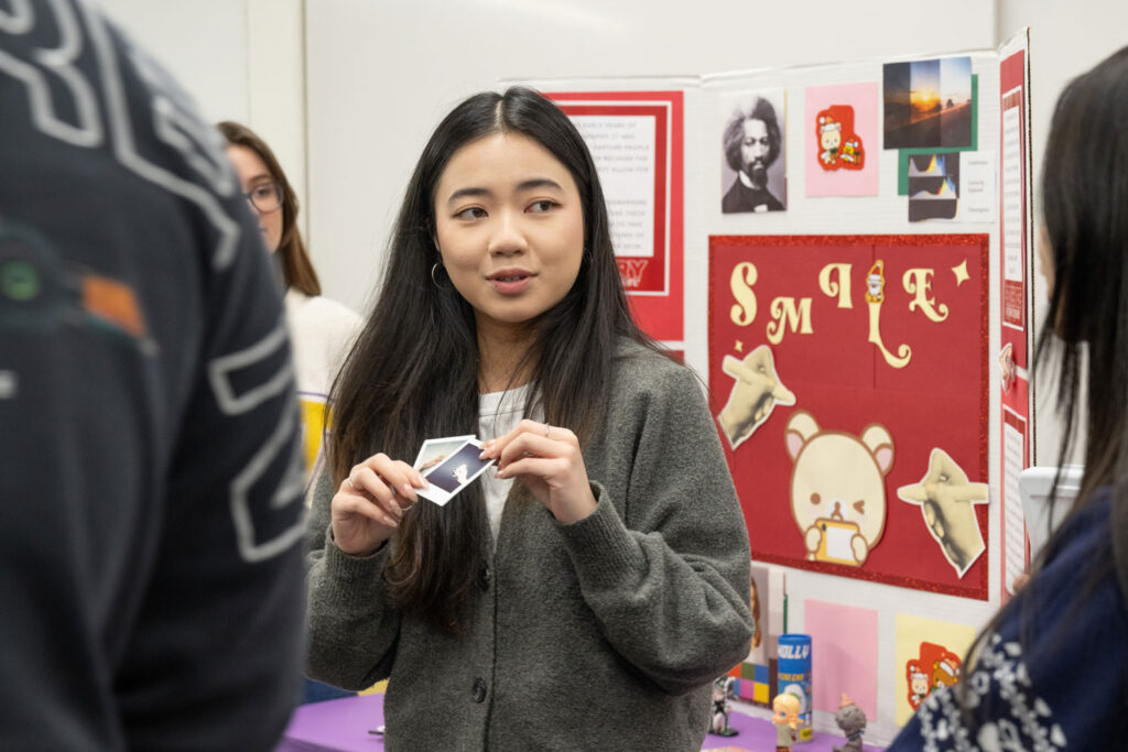 A person holding photographs.