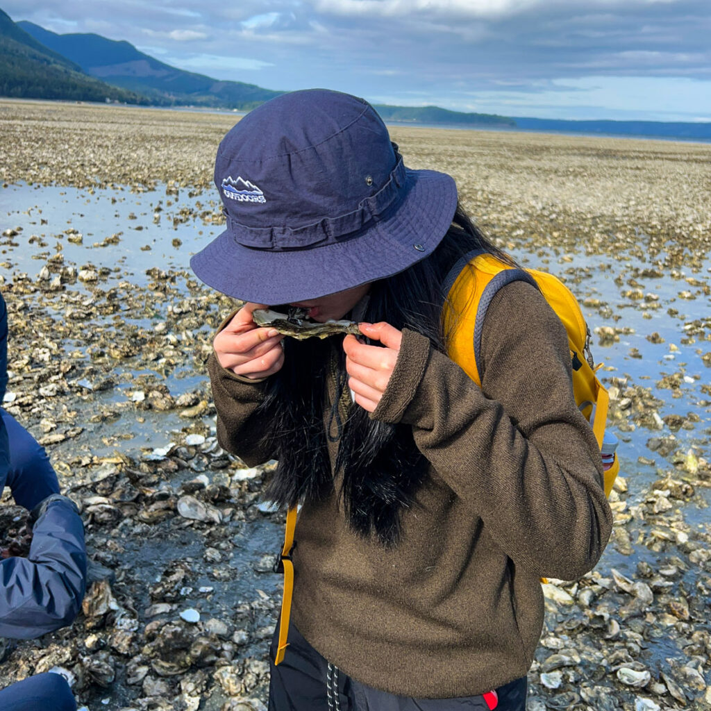 A person eating an oyster.