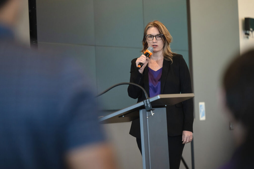 A person speaking at a podium.