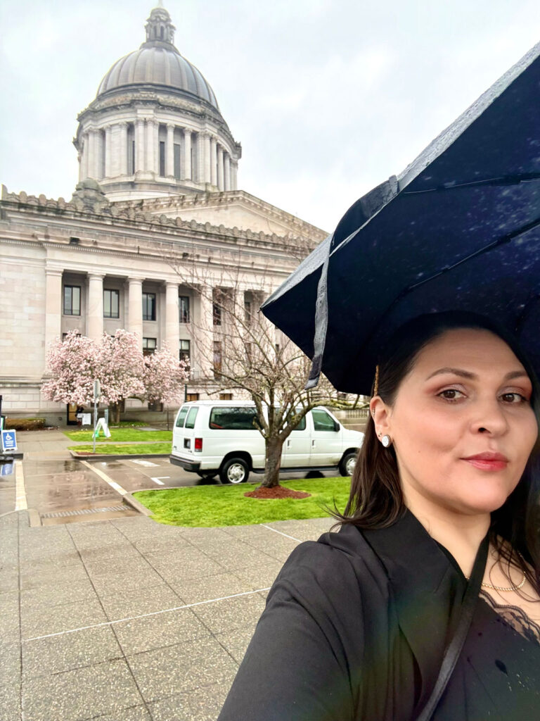 A person with a government building in the background.