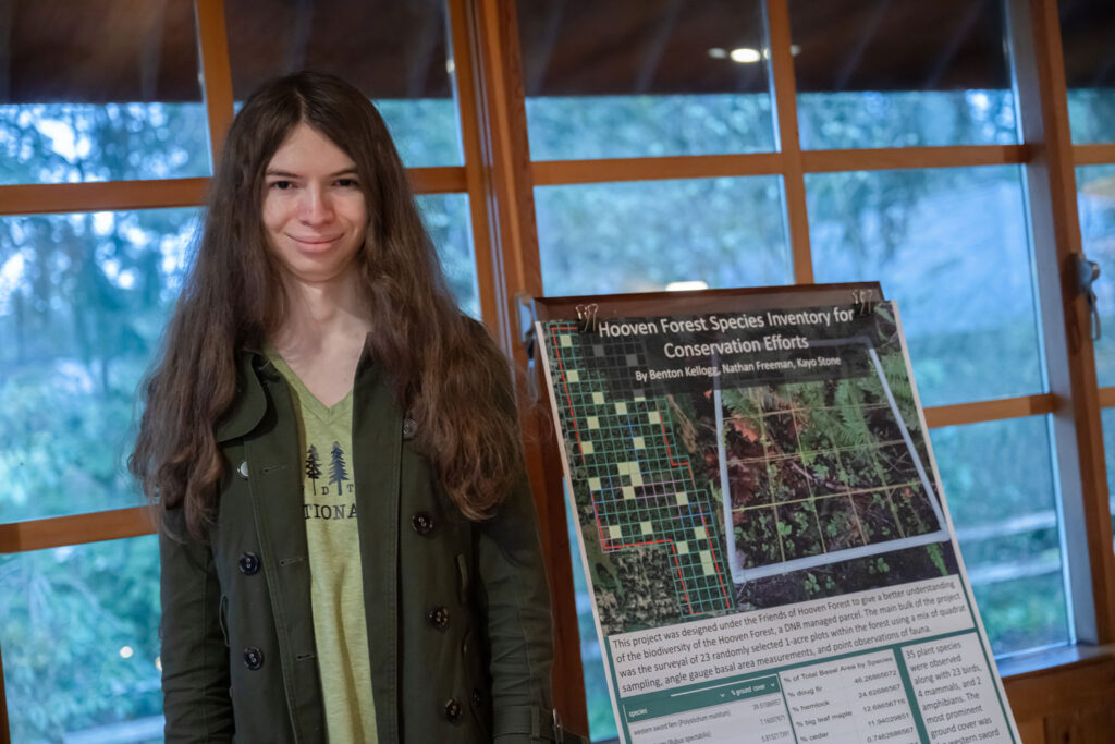 A person in front of a poster. 