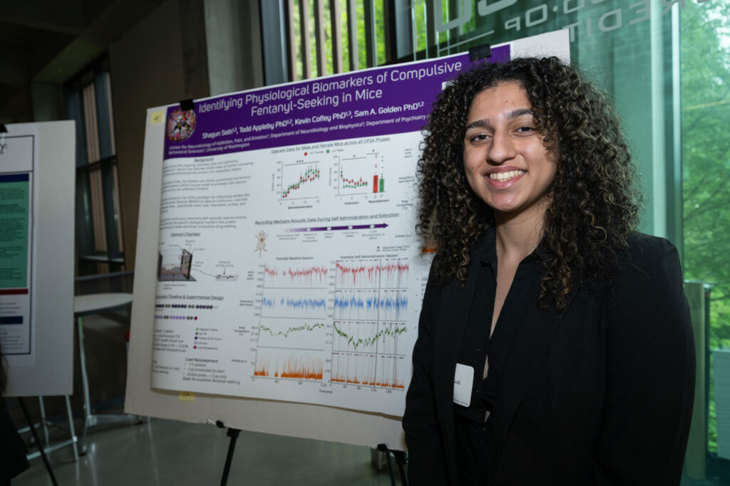 A person in front of a poster.