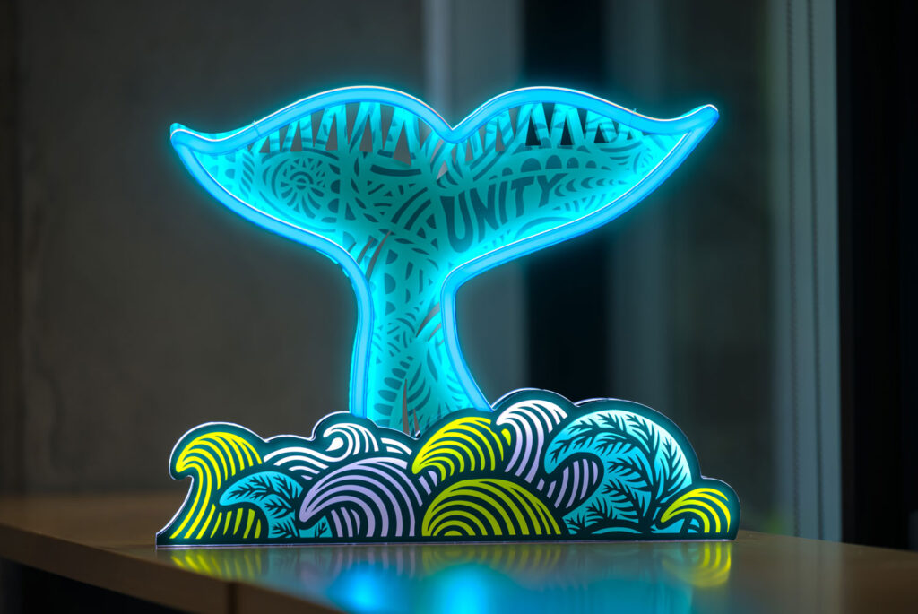 A neon sign of a whale tail.