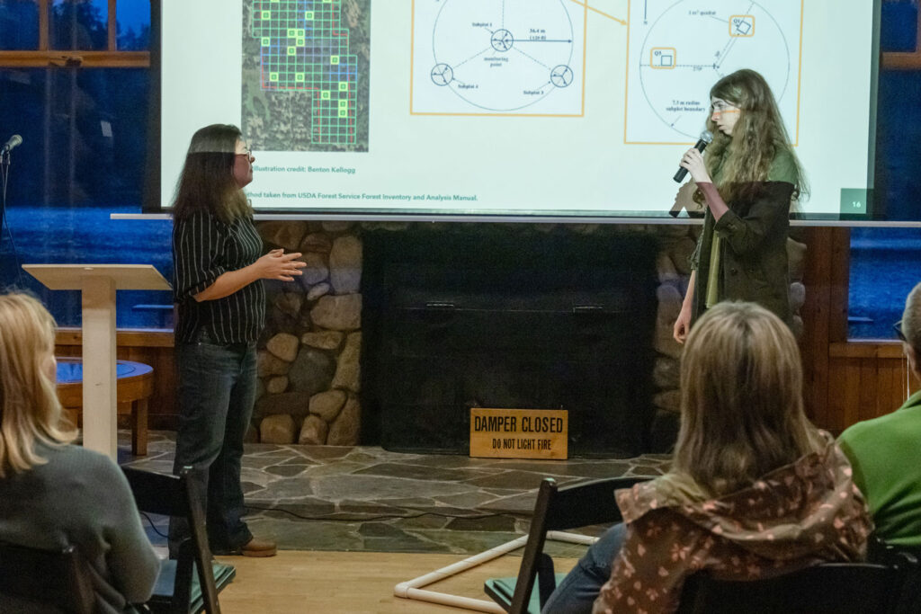 Two people presenting to a crowd.