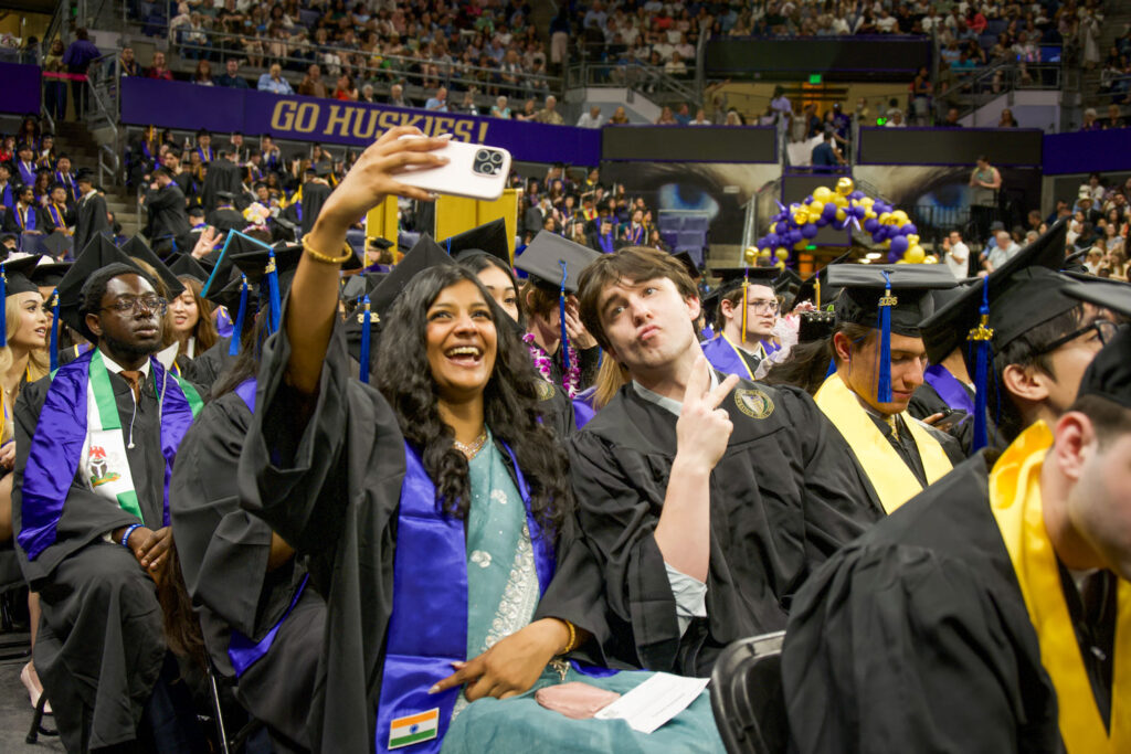 Graduates taking selfies.