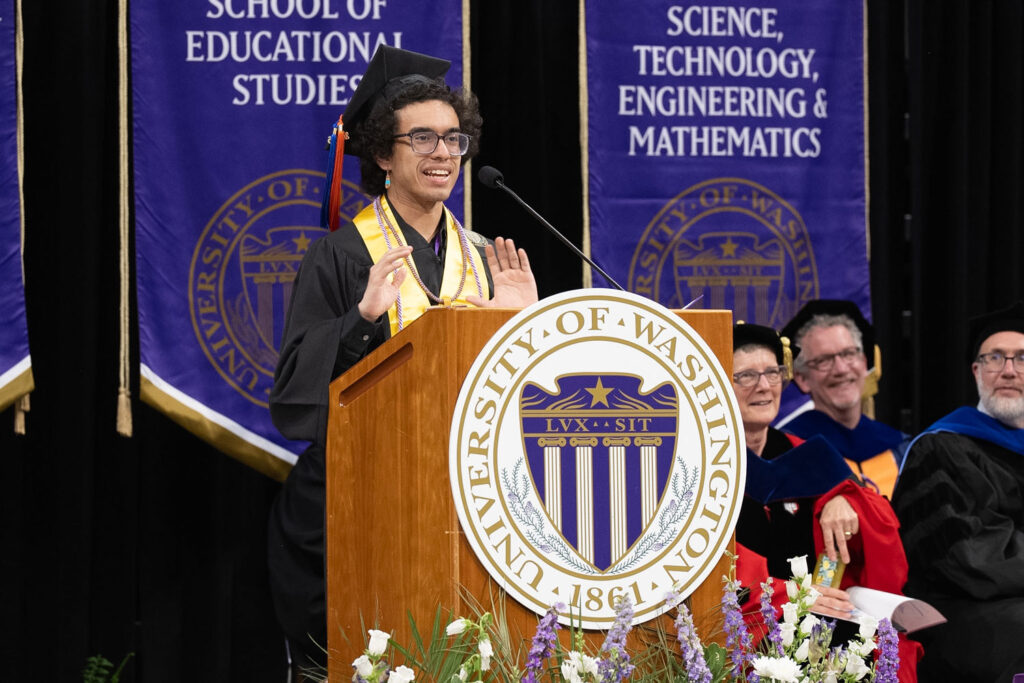 A person speaking behind a podium.
