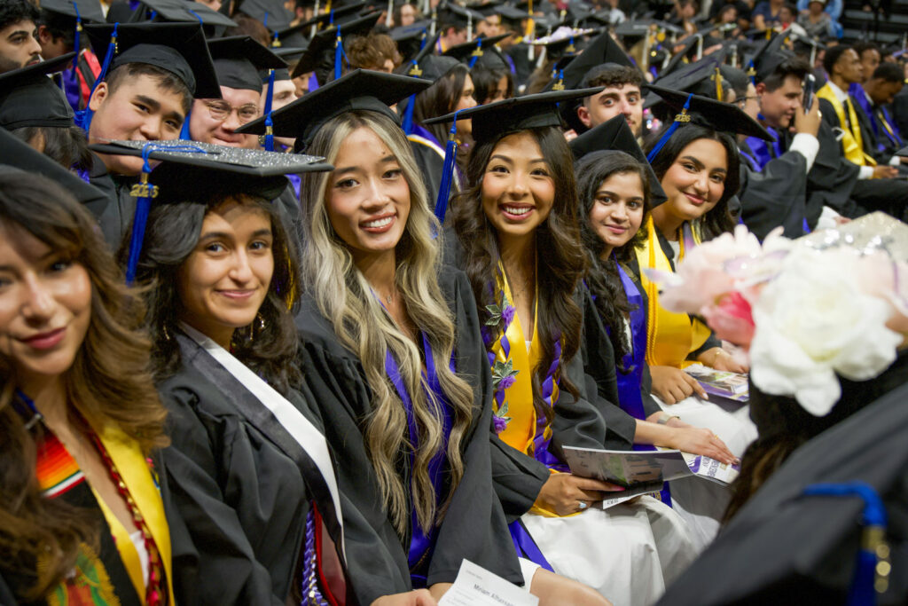 People in graduation attire.
