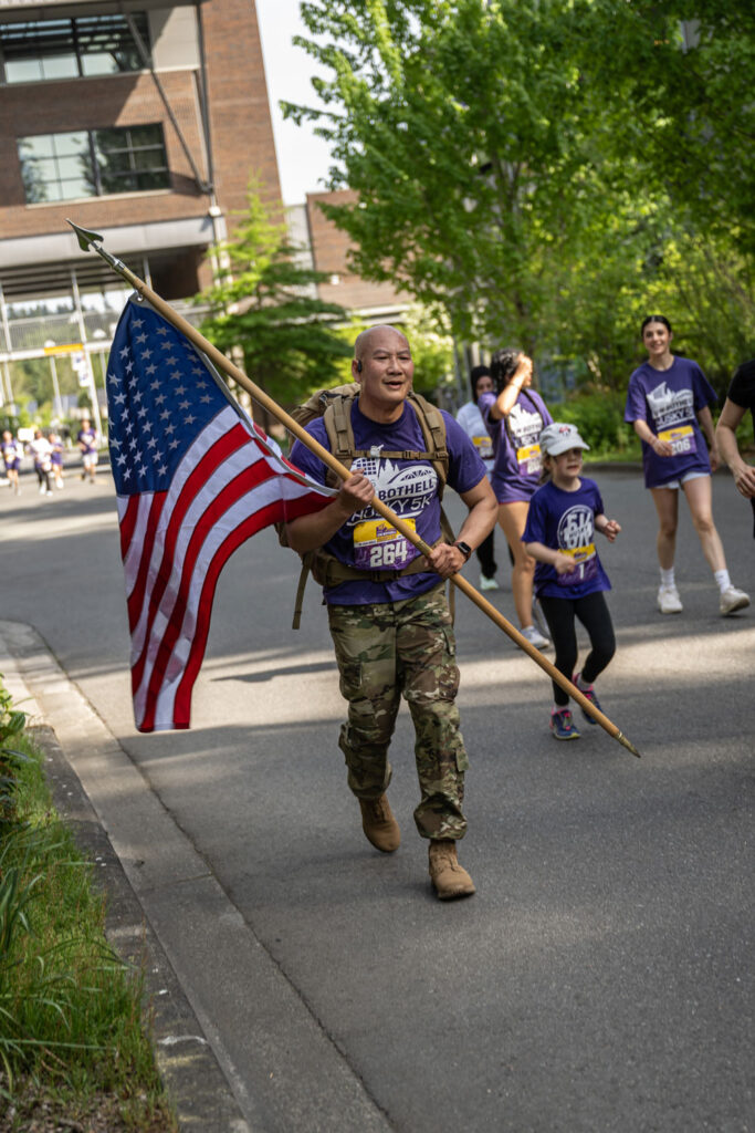 A person running with an American flag.