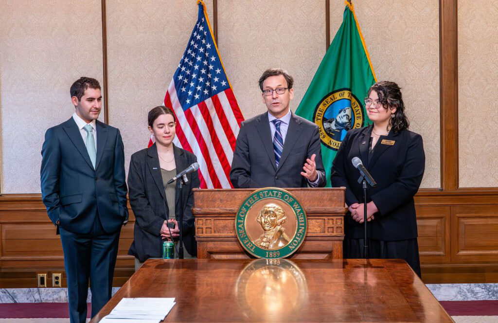 Four people at a podium.