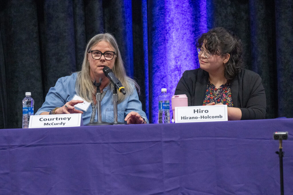 Two people on a panel discussion.