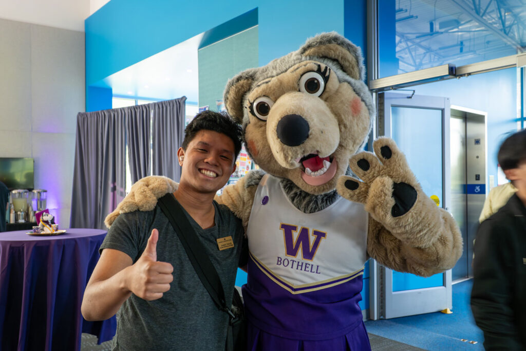 A person with a mascot.