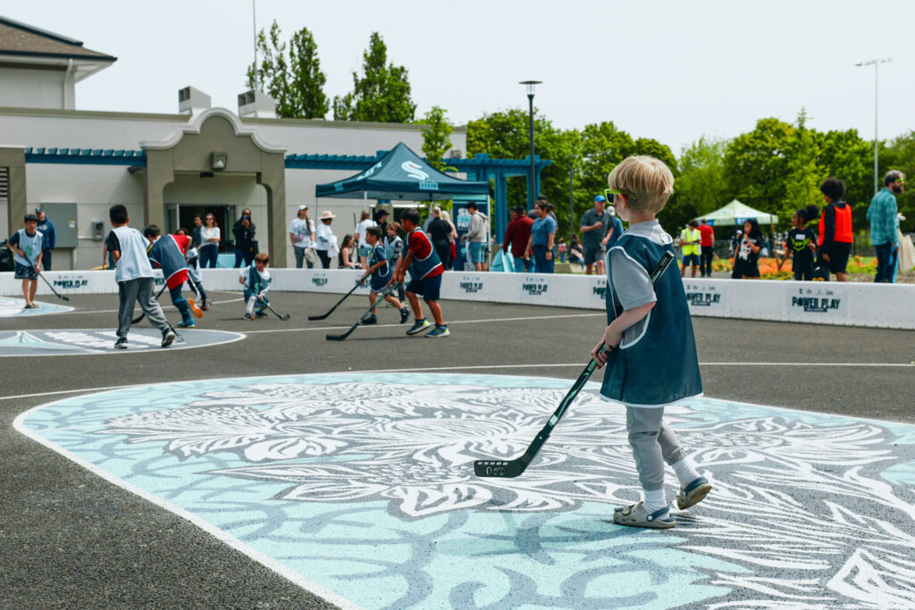 Children playing field hockey.