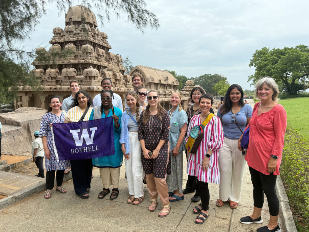 A group of people holding a UW Bothell flag.