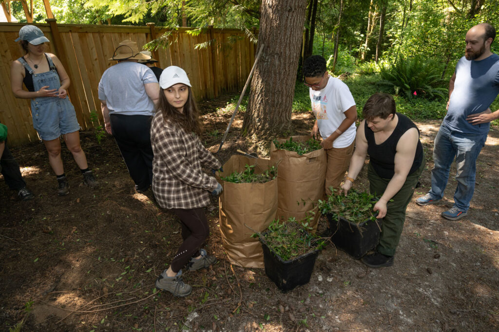 People packing yard waste into bags.