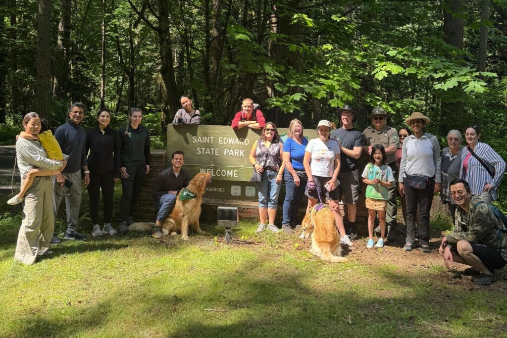 A group of people near a sign for "Saint Edward State Park."
