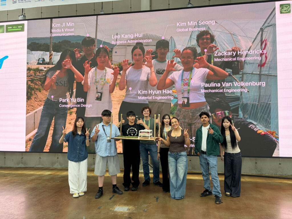 A group of people holding a device.