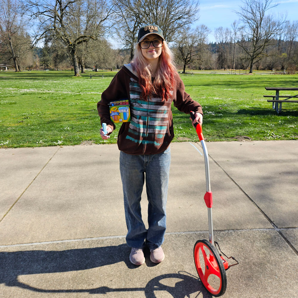 A person holding a surveying measuring tool.
