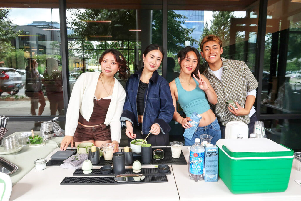 Four people behind a matcha bar.