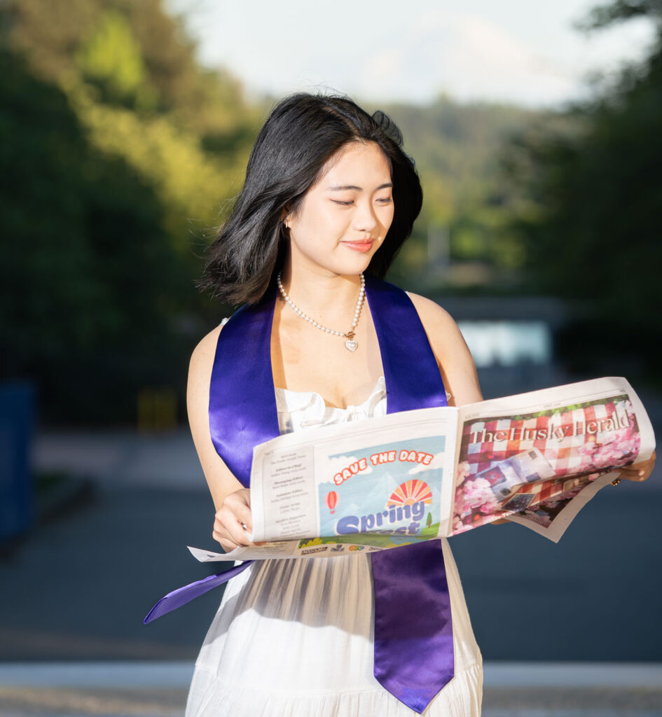 A person posing with a newspaper.