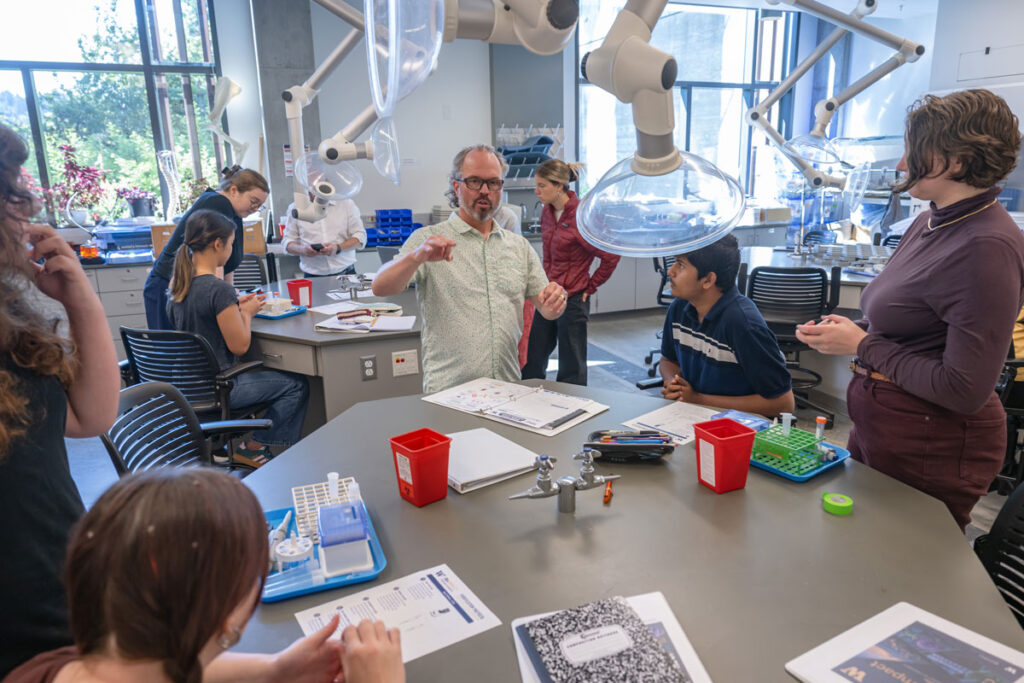 A classroom of people sitting at lab tables.