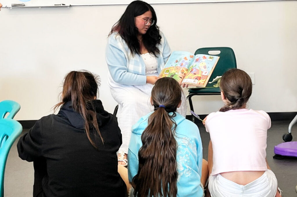 A person reading to a group of children.