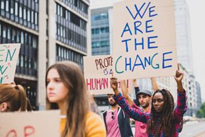 People with signs "we are the change"