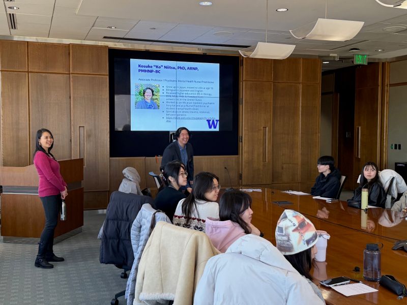 faculty in front of powerpoint screen