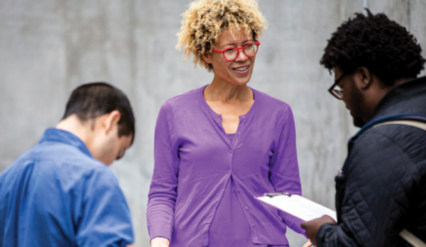 faculty and students with clipboards