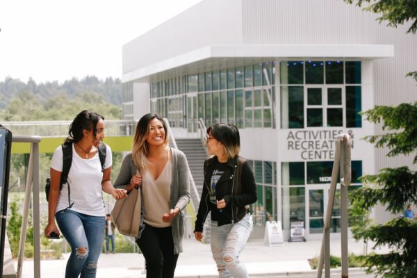 three bothell students walking near the activities and recreation center on the bothell campus
