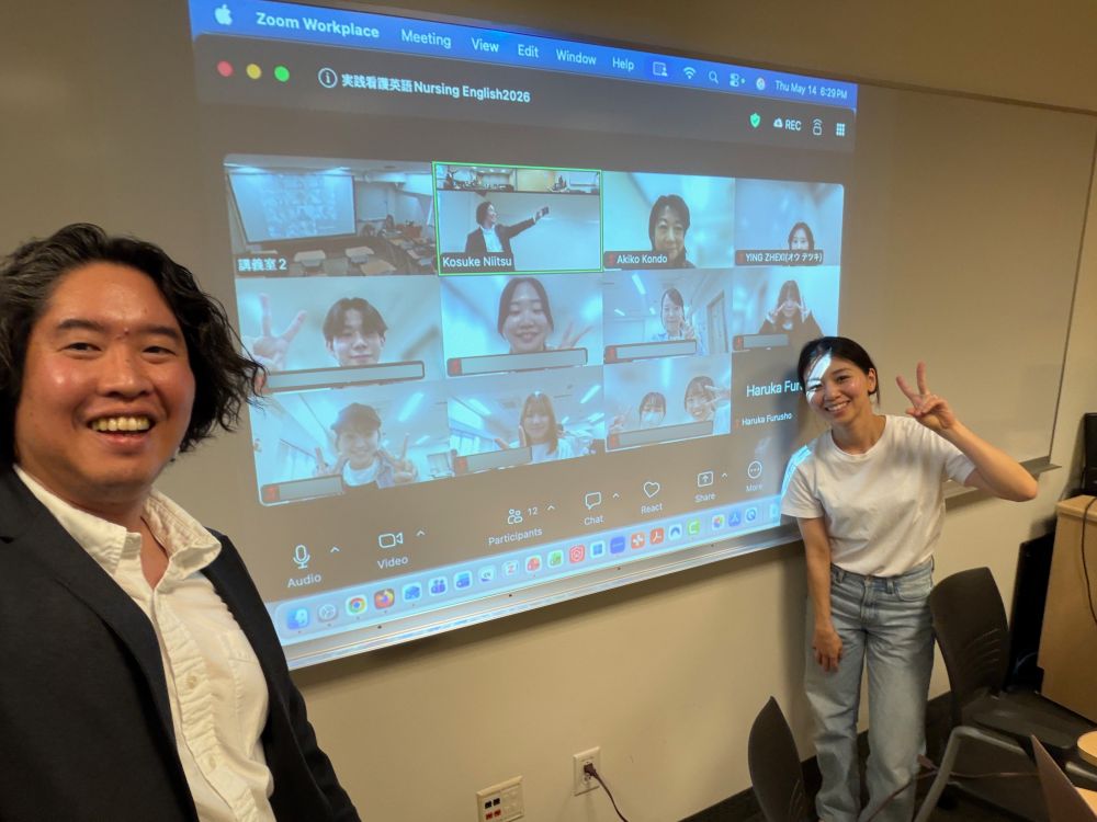 presenters in front of powerpoint slide displayed on screen 