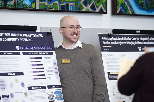 graduate student showing their capstone poster