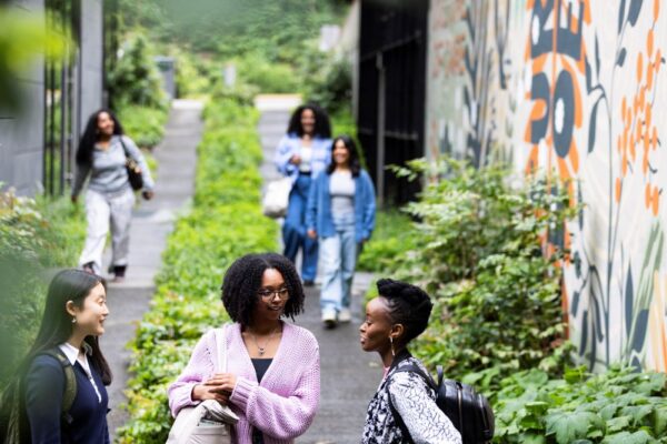 3 students talking on campus