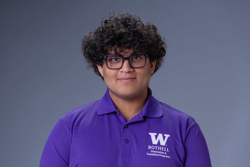 Peer Coach Vihan in a purple polo in front of a gray background