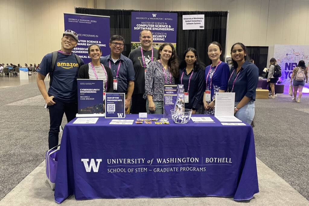 Students, faculty and staff at the University of Washington Bothell School of STEM Division of Computing & Software Systems booth representing STEM Graduate Programs in the GHC Expo Hall