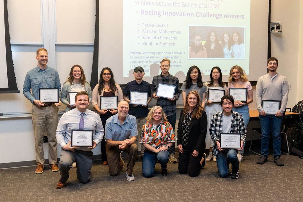 Physical sciences division chair Daniel Jaffe and associate teaching professor Heather Galindo posing with students who received their awards.