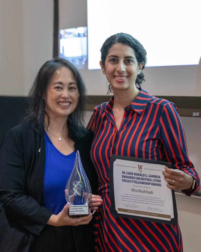 Dr. Afra Mashhadi holding certificate and Michelle Gamboa holding glass award, shaped like a water drop