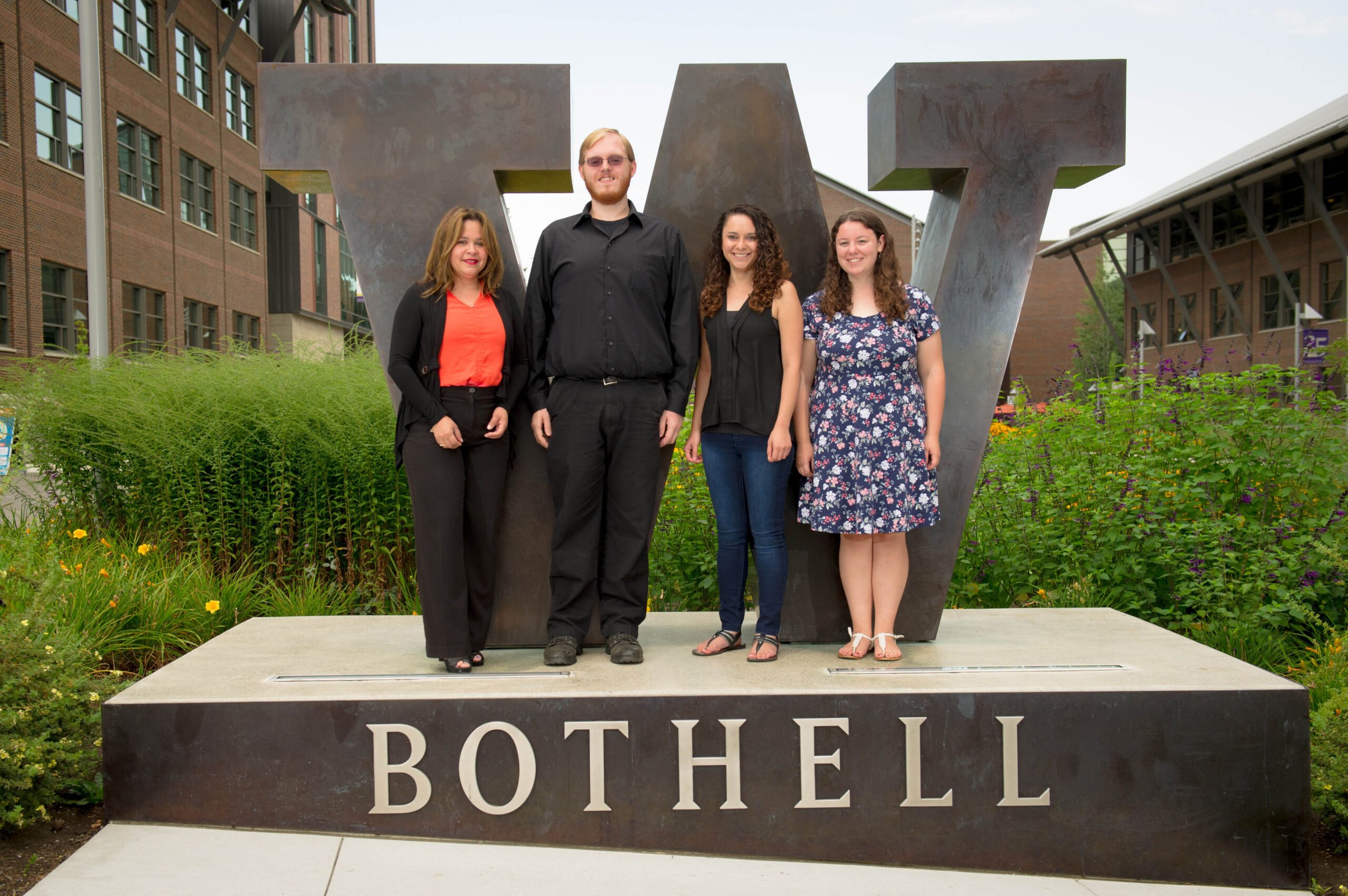 Optimization group of students with their mentor at the W Bothell statue