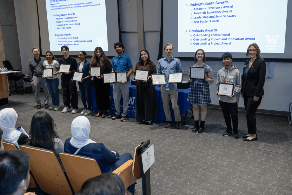 Computing & Software Systems department awardees holding their certificates, standing in a line with Acting Department Chair Dr. Johnny Lin and Dean Jennifer McLoud-Mann