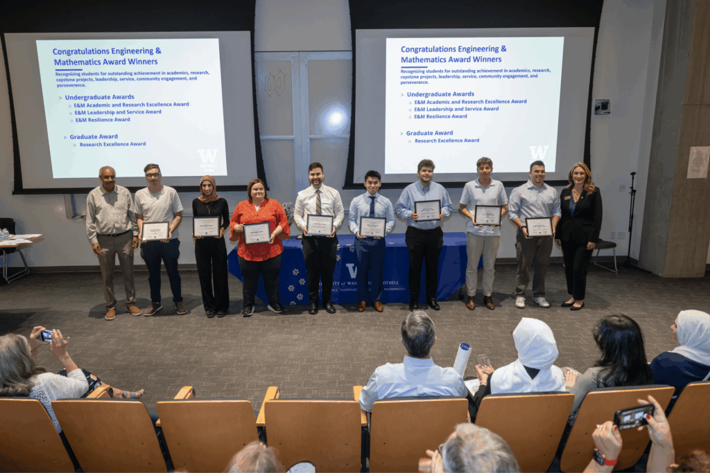 Engineering & Mathematics department awardees holding their certificates, standing in a line with Department Chair Dr. Tadesse Ghirmai and Dean Jennifer McLoud-Mann