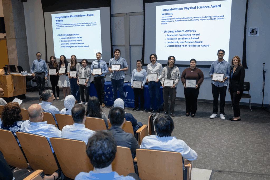 Physical Sciences department awardees holding their certificates, standing in a line with Department Chair Eric Salathé and Dean Jennifer McLoud-Mann