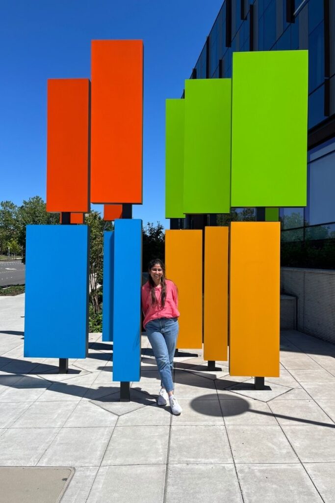 Jui stands next to a structure symbolizing the Microsoft logo.
