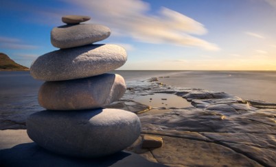 stacked rocks against an ocean background