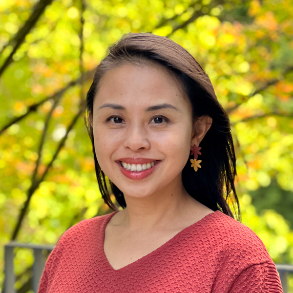 Asian woman with long black hair wearing a red sweater