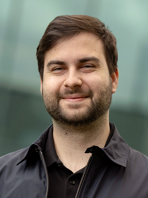 Close-up portrait of Daniel Dirdala wearing a black jacket and black polo.